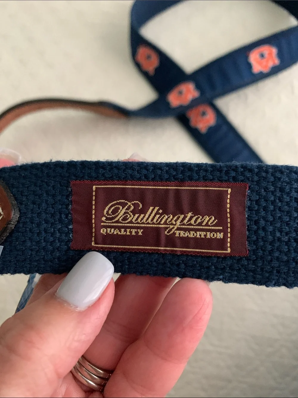 Navy Web Belt with Orange Logo Accents and Brown Leather Trim